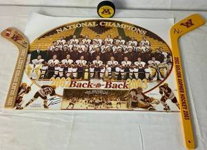 lot 171 image: University of Minesota Mini Hockey Sticks Autographed by Head Coach Dan Lucia, 20022003 Back to Back Championship Poster Autographed by Thomas Vanek and Gopher Hockey Puck