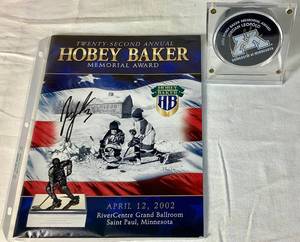 lot 160 image: Jordan Leopold Autographed Hockey Puck and Autographed Hobey Baker Award Program April 12, 2002