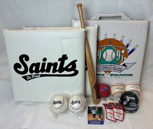 lot 145 image: Saint Paul Saints Bundle - Commerative Bat and Baseballs, 1997 Seat Cushion, 2 Seat Cushions, Saints 2000 Snow Globe and Two 1998 Game Balls
