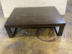 lot 422 image: Watson Rectangular Cocktail Table Dark Brown - Signature Design by Ashley Modern Trestle Base, Hardwood Veneer 16.63 Inches (H) x 56.06 Inches (W) x 42.06 Inches (D) (Transit Damage, See Photos)