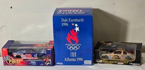 lot 151 image: NASCAR Die Cast Model Cars - 124 - Racing Champions  Action  Sports Image - Quality Care Ford Taurus #88 Dale Jarrett  Bass Pro Shops Chevrolet Monte Carlo #3 Dale Earnhardt  Atlanta Olympics Chevrolet Monte Carlo #3 Dale Earnhardt