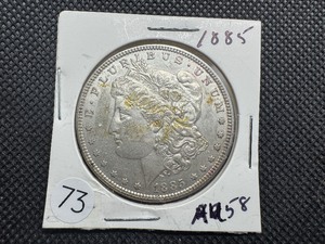lot 73 image: 1885 Morgan Silver Dollar Marked AU58 When Purchased