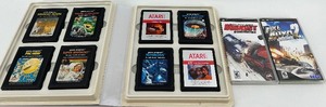 lot 14 image: Collection of Atari 2600 Cartridges in Binder and 2 PSP Racing Games