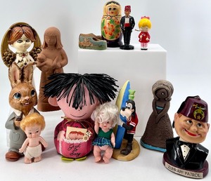 lot 109 image: Collection of 13 Vintage Figurines and Dolls Including Goofy, Matryoshka, and Character Pieces