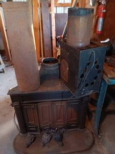 lot 158 image: Used Cast Iron Wood Burning Stove with Ornate Feet and Vent Pipes