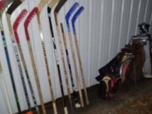 lot 71 image: Sports Equipment Lot Hockey Sticks, Golf Bags with Clubs, and Water Bottle Carrier