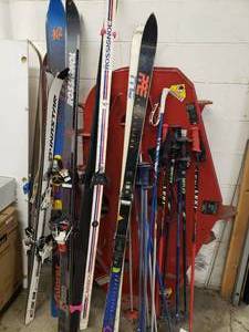 lot 51 image: Lots of snow skis, poles down hill and cross country