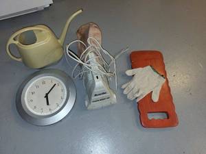lot 253 image: Household Utility Lot Wall Clock, Watering Can, ReadiVac Power Brush Vac, Garden Kneeler, and Work Glove