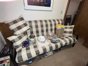 lot 133 image: Black Metal Futon with Plaid Cushions and Pillows