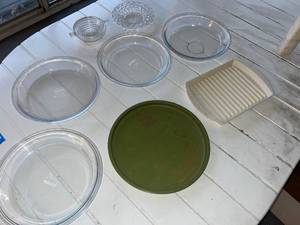 lot 139 image: Assorted Kitchenware Lot Including Pyrex Pie Plates, Vintage South Dakota Tin, and Serving Dishes