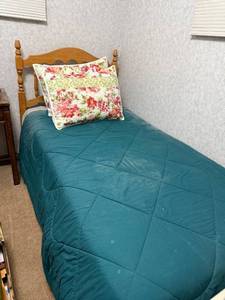 lot 81 image: Twin Size Wooden Bed Frame with Teal Comforter and Floral Pillow Shams