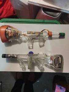 lot 208 image: 2 Empty Glass Bottles Shaped Like Machine Guns