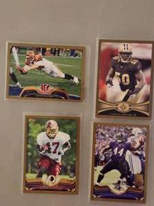 lot 173 image: Four Collectible NFL Football Trading Cards.
