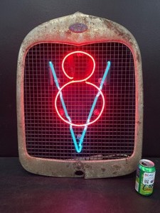 lot 146 image: V8 neon mounted on Ford grill