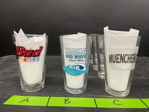 lot 187 image: Lot of pint glasses, Kona Big Wave Liquid Aloha, Bud NASCAR Talladega Superspeedway, and Muenchener