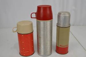 lot 52 image: Vintage Thermos Bottles Trio Including Hiawatha and Happy Home