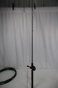 lot 76 image: Shakespeare Ugly Stik GX2 Casting Rod with Reel and Green Rod Sleeve