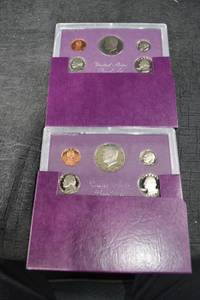 lot 249 image: Two 1985s United States Mint 5-Coin Sets - Purple Presentation Wallets