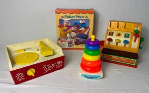 lot 63 image: Vintage Fisher Price Toys #627 Rock-A-Stack, Music Box Record Player, Baking Fun and Cash Register
