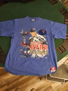 lot 219 image: Vintage 1993 Nutmeg Mills Nolan Ryan Texas Rangers T-shirt in blue. - Size XL