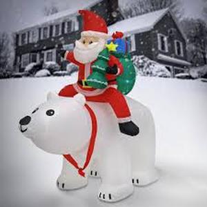 lot 31 image: National Tree Company 6 ft. Inflatable Santa Riding Polar Bear.
