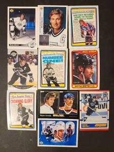 lot 238 image: Collection of vintage Wayne Gretzky collectors hockey cards featuring various teams and career milestones.