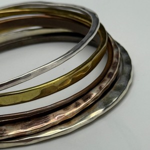 lot 11 image: Robert Lee Morris Mixed-Metal Jewelry Lot  Bangles & Earrings