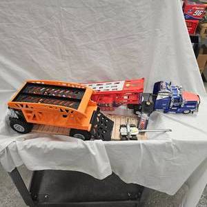 lot 87 image: Remote Semi and Trailer, Hot Wheels Bone Shaker Truck and Log Trailer
