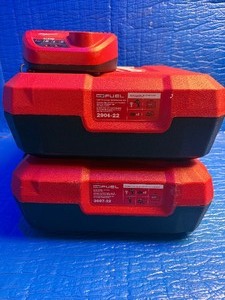 lot 43 image: Two empty cases and one M-12 charger