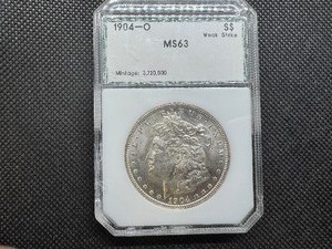 lot 26 image: 1904 O PCI MS 63 Morgan Silver Dollar