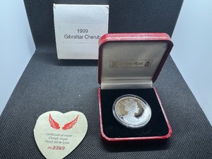 lot 76 image: 1999 Gibraltar Cherub 1 oz Silver Round in Display Case