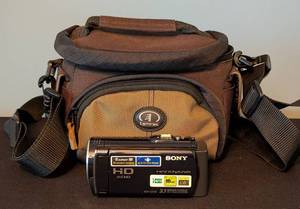 lot 134 image: LR - Sony HDR-CX150 Handycam HD Camcorder with Tamrac Carry Case