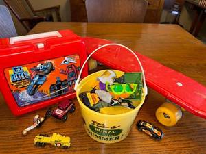 lot 64J image: Vintage GoBots Lunchbox with Thermos, Red Skateboard, and Toy Vehicle Collection