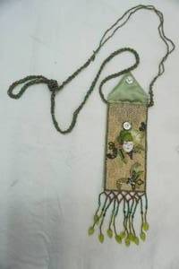 lot 377 image: Beaded Medicine Bag with Small Ceramic Face