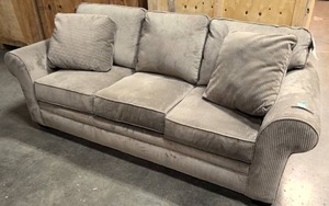 lot 4 image: Upholstered Sleeper Couch with tags still on it
