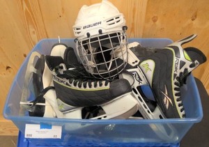 lot 22 image: Tote with two pairs of hockey skates, 2 pairs of figure skates, and hockey helmet