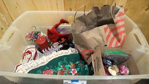 lot 34 image: The Xmas tote  tree skirt, misc dcor, xmas tins, xmas candle holders