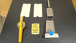 lot 100 image: two Cheese graters, two Egg dishes, slicer, and press