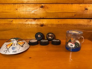 lot 9 image: Collectible MN Wild Hockey Pucks including an official game puck, Wild Hockey Mask, Wild Marion Goborick Celebird (look at pictures)