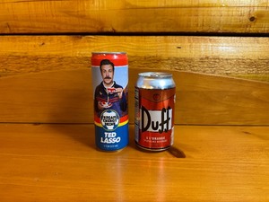 lot 20 image: Ted lasso Pregame Energy Drink and The Simpsons Duff A Lorange Sparkling Beverage (UnopenedFull)