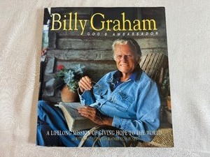 lot 247 image: Billy Graham Gods Ambassador A Lifelong Mission of Giving Hope to the World by Russ Busby Paperback Book