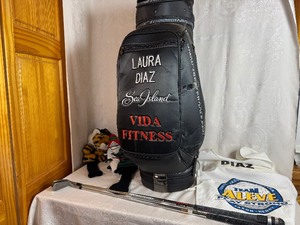 lot 248 image: Laura Diaz Autographed Golf Bag, Laura Diaz Autographed Caddie Vest, Two Clubs and Two Club Covers