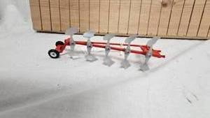 lot 266 image: International 5 Bottom Plow Mounted