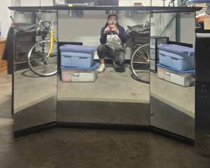 lot 97 image: MCM Furnlite 3-Panel Lighted Vanity Mirror with Black Wood Cabinet, 59x41x16 in