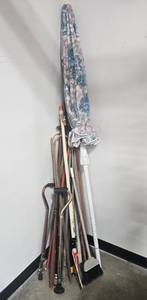 lot 100 image: Mixed Lot of Yard Tools and Canes Including Umbrella, Broom, and Walking Canes