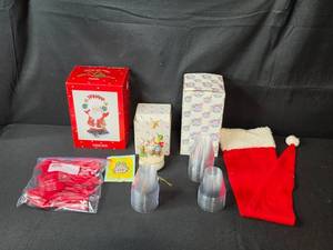 lot 229 image: Christmas Holiday Decor Collection with Dreamscicles Figurine, Hello Cucumber Music Box, Santa Hat, and Party Supplies
