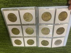 lot 61 image: Booklet Brass Plated Sports Coins made by Pinnacle