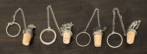lot 701R image: LL - Set of 4 Decorative Metal and Cork Bottle Stoppers with Chains