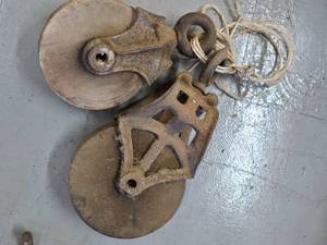 Barn pullys, hay hook, scissors, and a cast grill cover