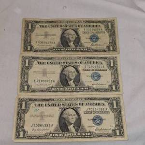lot 58 image: (3) 1957 Series $1 Silver Certificates